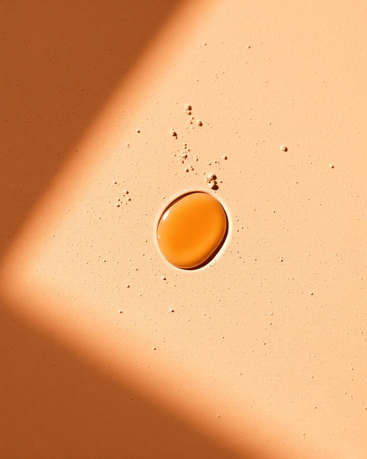 Macro of warm earthy texture with serum drop